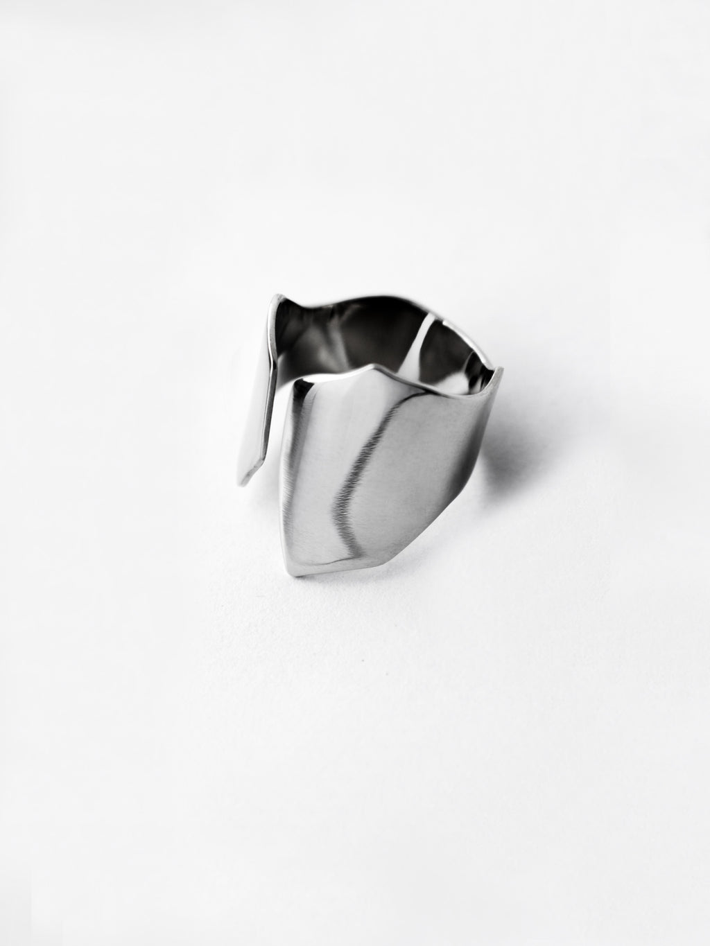 Adjustable sculptural silver ring on a white background