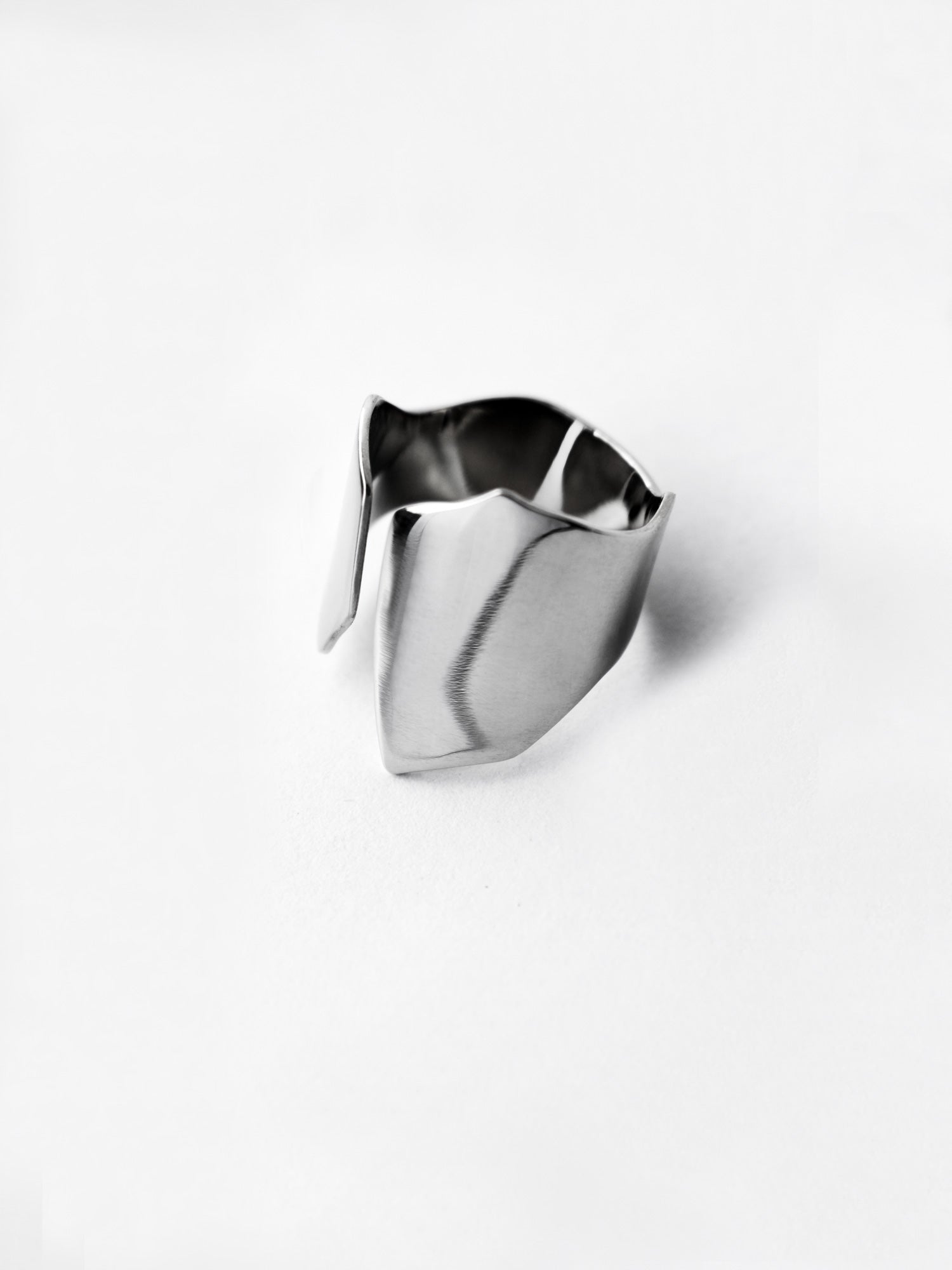 Adjustable sculptural silver ring on a white background