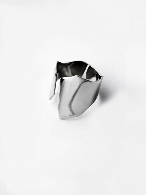 Adjustable sculptural silver ring on a white background