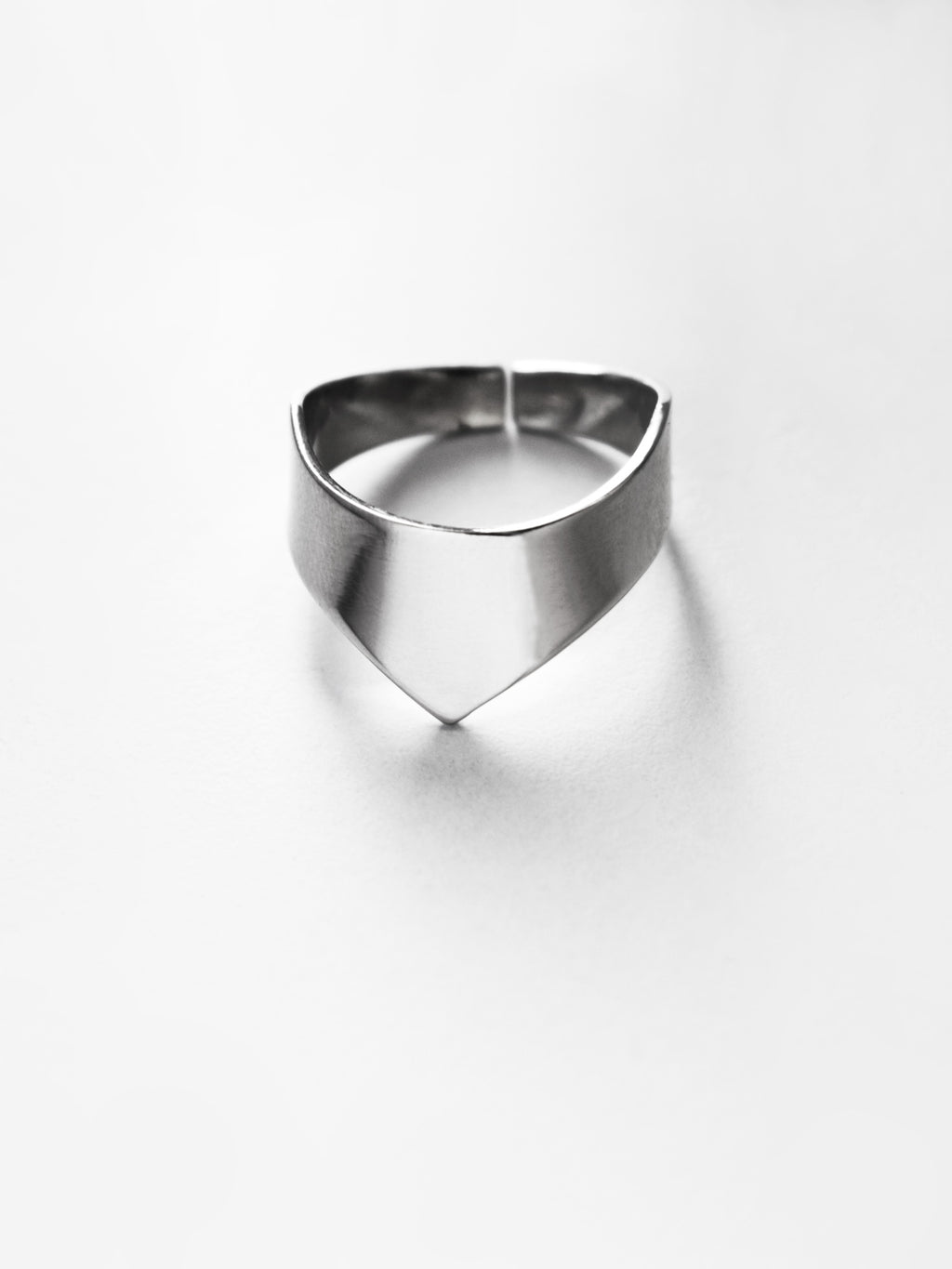 Adjustable silver ring with an angular band on a white background