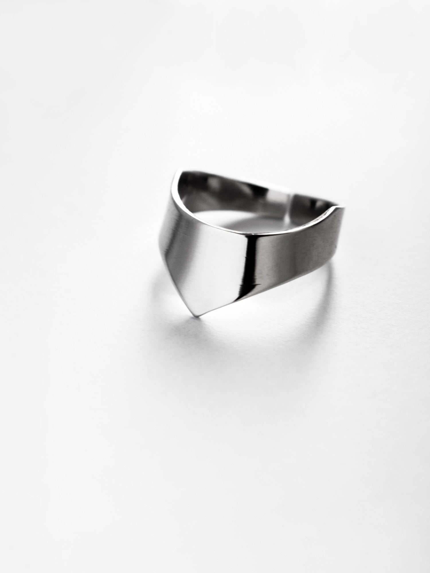 Adjustable silver ring with an angular band on a white background