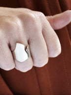 Close-up of a hand wearing an adjustable sculptural silver ring