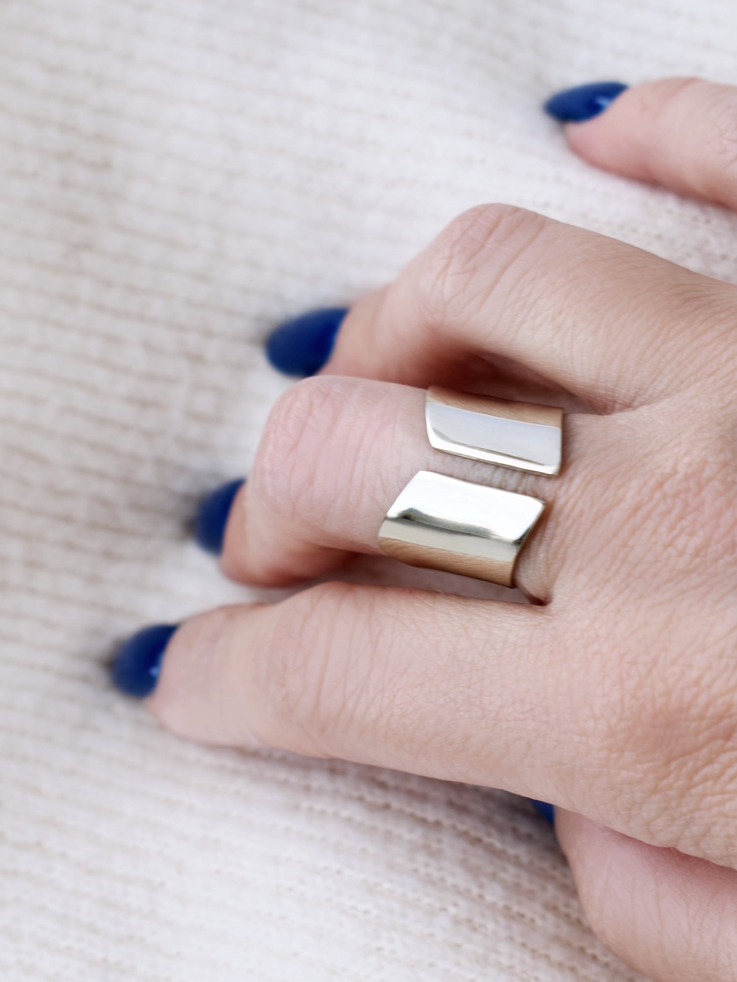 Close-up of a hand wearing an adjustable sculptural silver ring
