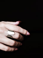 Close-up of a hand wearing an adjustable sculptural silver ring