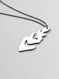 Silver leaf-shaped pendant with chain on a light gray background
