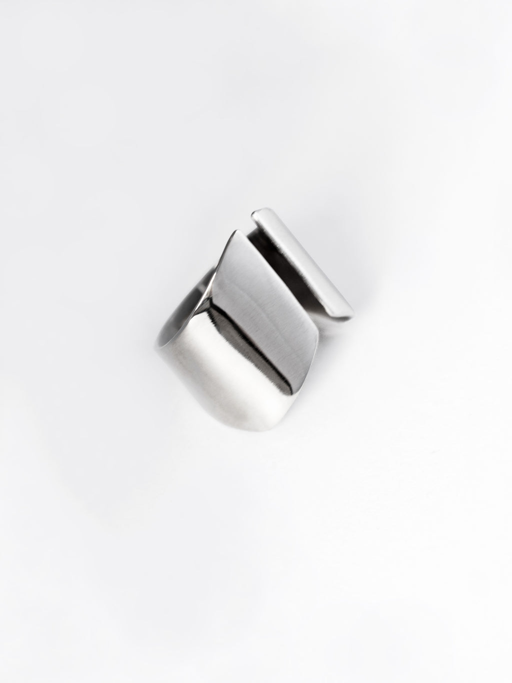 Adjustable sculptural silver ring on a white background
