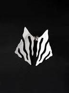 Pair of abstract-shaped silver stud earrings with flowing cutouts on a black background