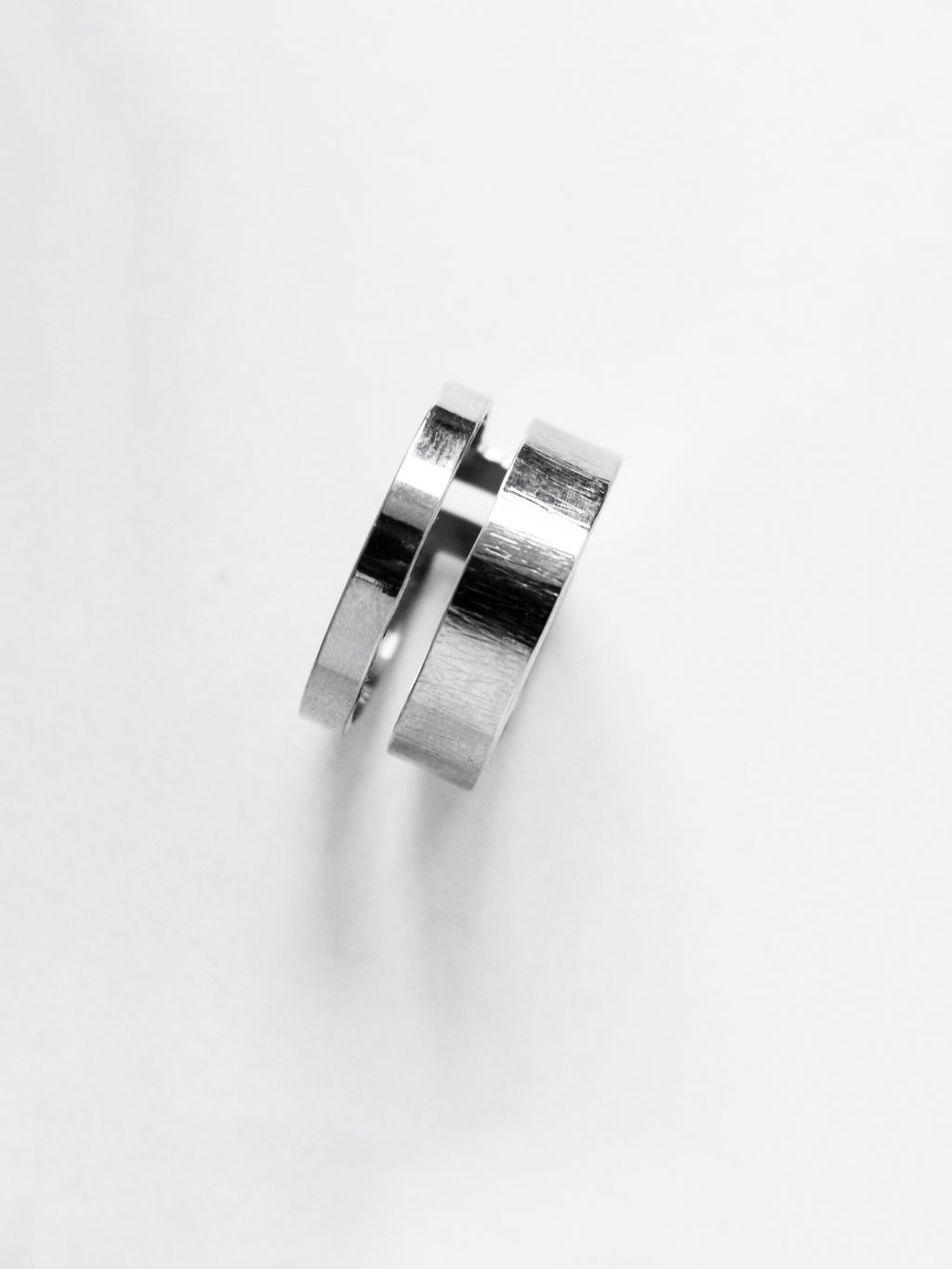 Adjustable double-band silver ring on a white background