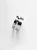 Adjustable double-band silver ring on a white background