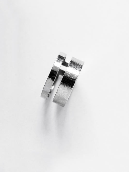 Adjustable double-band silver ring on a white background