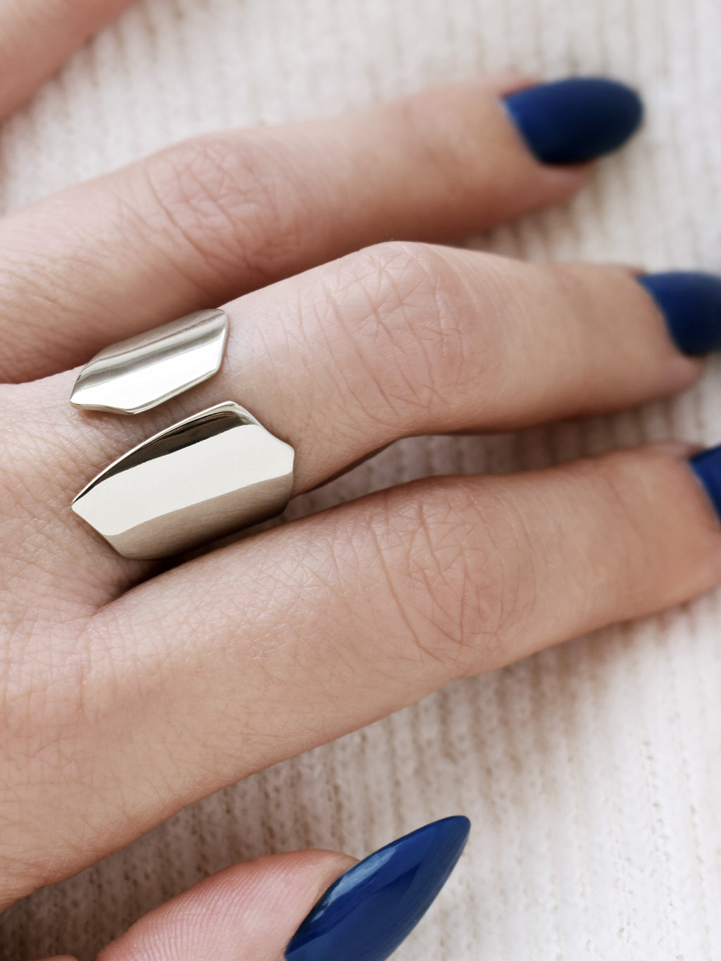Close-up of a hand wearing an adjustable sculptural silver ring
