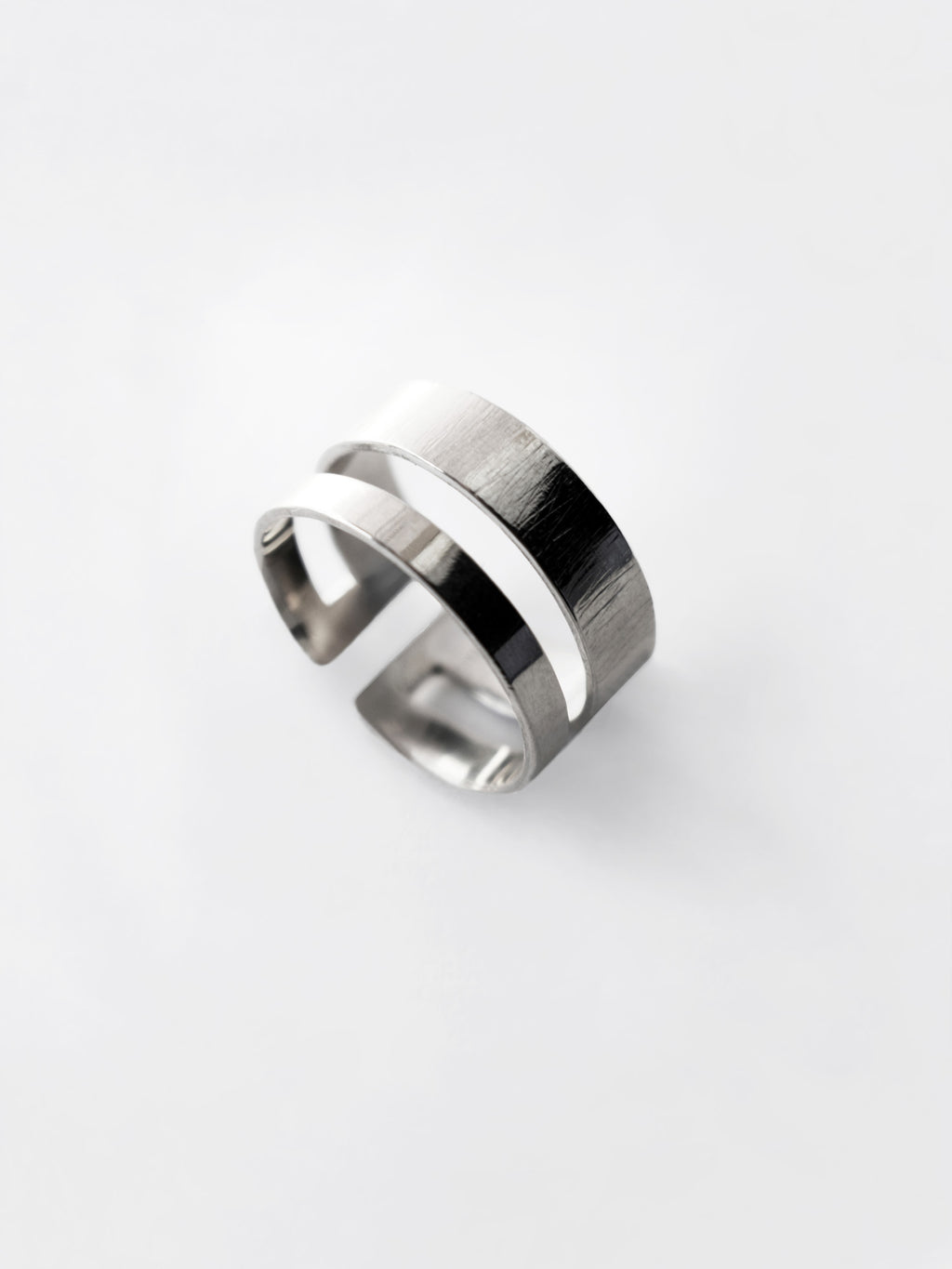 Adjustable double-band silver ring on a white background