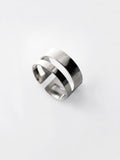 Adjustable double-band silver ring on a white background