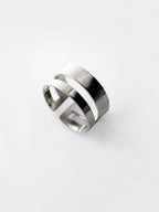 Adjustable double-band silver ring on a white background