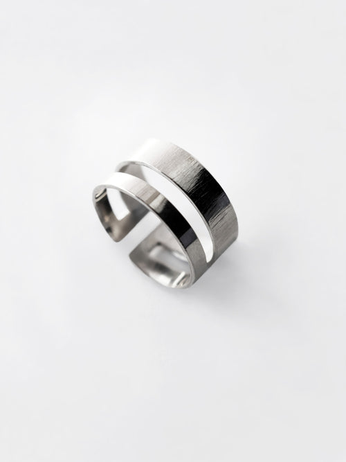 Adjustable double-band silver ring on a white background