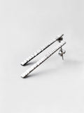 Pair of textured silver bar stud earrings on a light gray background