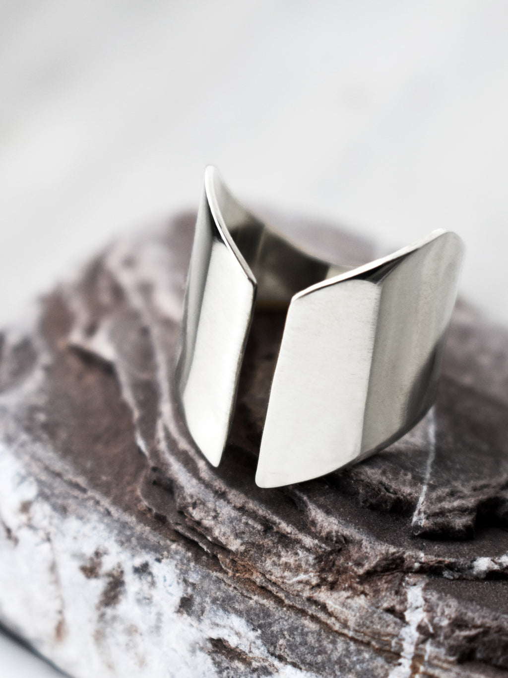 Adjustable sculptural silver ring on a textured stone