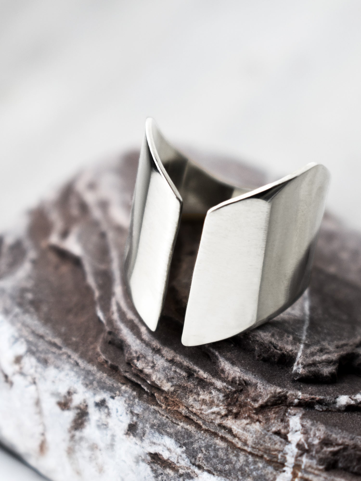 Adjustable sculptural silver ring on a textured stone