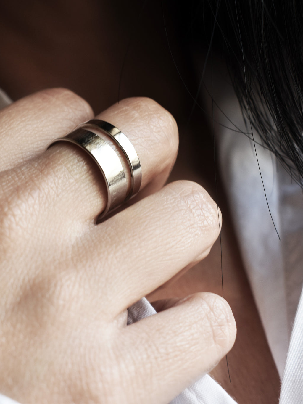 Close-up of adjustable double-band silver ring on a woman's hand