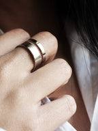 Close-up of adjustable double-band silver ring on a woman's hand