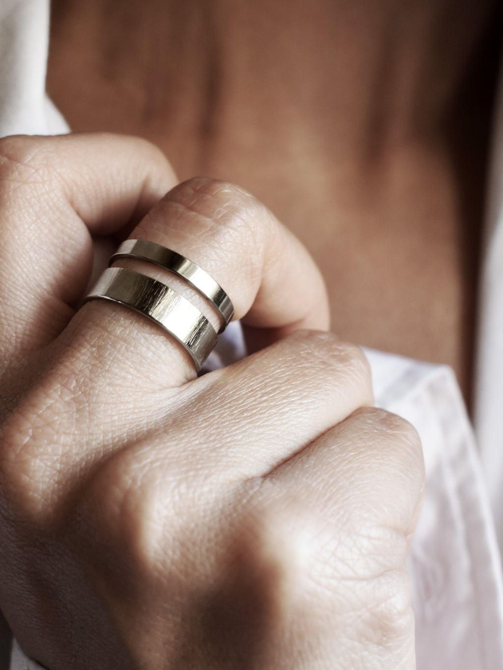 Close-up of adjustable double-band silver ring on a woman's hand