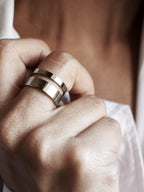 Close-up of adjustable double-band silver ring on a woman's hand